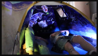 Alexandra Hammond, Participants inside "StoryHut." Acrylic on modified camping tent, sound and mixed media. 4.5' x 6' x 4'. Photo courtesy of the artist, Alexandra Hammond